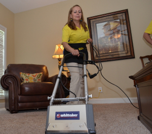 The Maids team member cleaning a carpet photograph