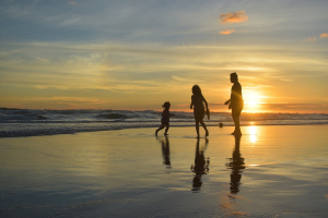 family vacationing on the beach