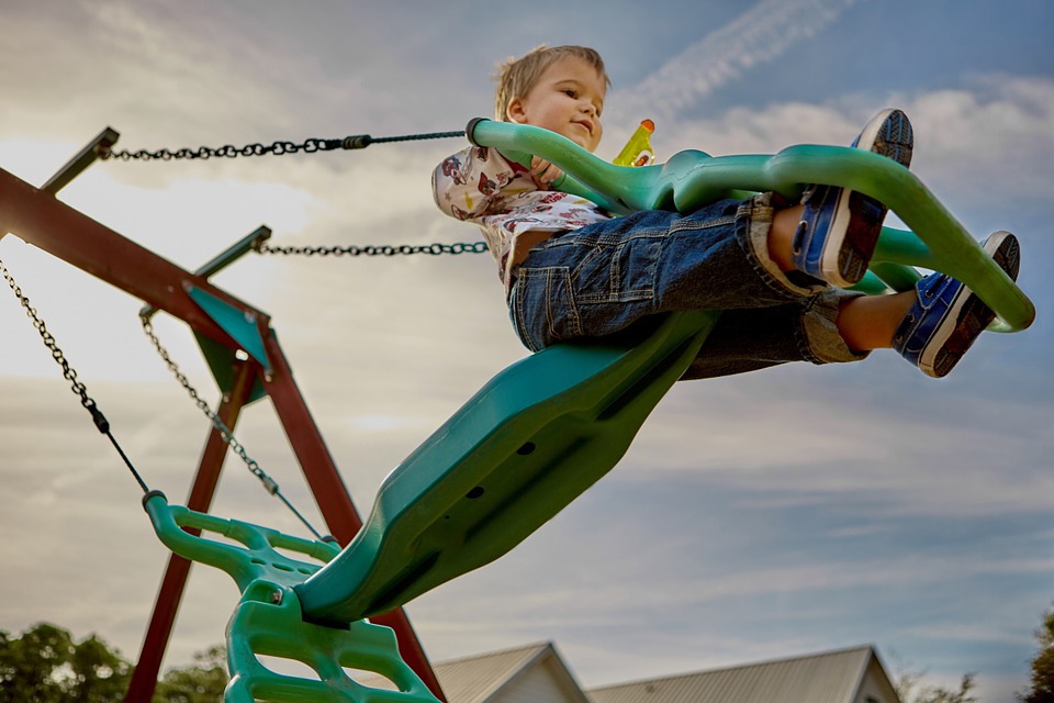 child on a swing at a playground