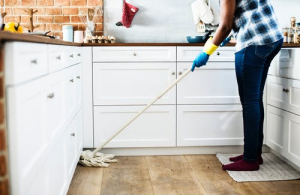 cleaning baseboards in kitchen