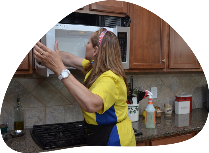 Maid team cleaning microwave