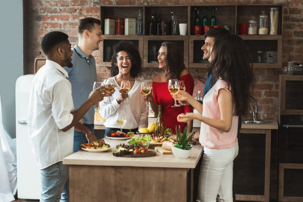 Group of cheerful young people enjoying dinner